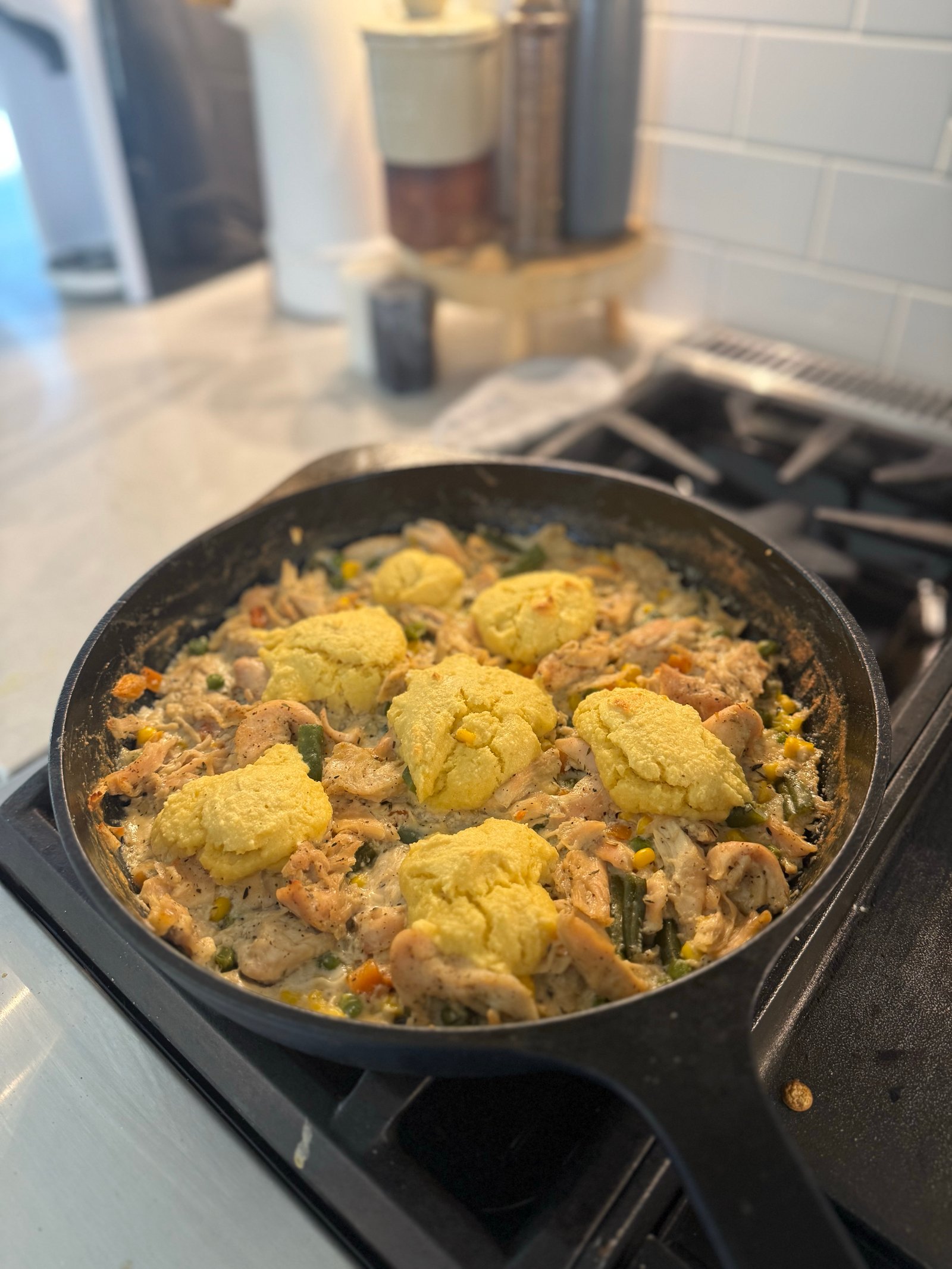 Chicken pot pie skillet topped with golden high protein biscuits